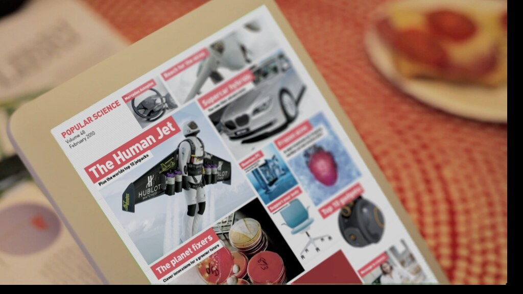 A Popular Science cover, 'The Human Jet', rendered on a touchscreen tablet resting on a breakfast table