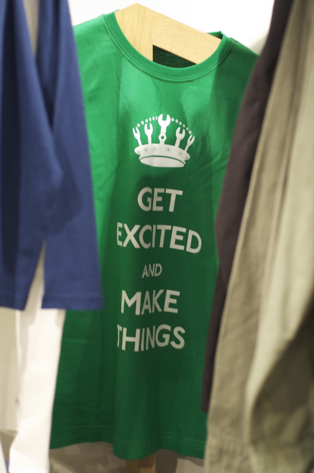 The Get Excited and Make Things t-shirt, white text on green, in the Howies store on Carnaby Street