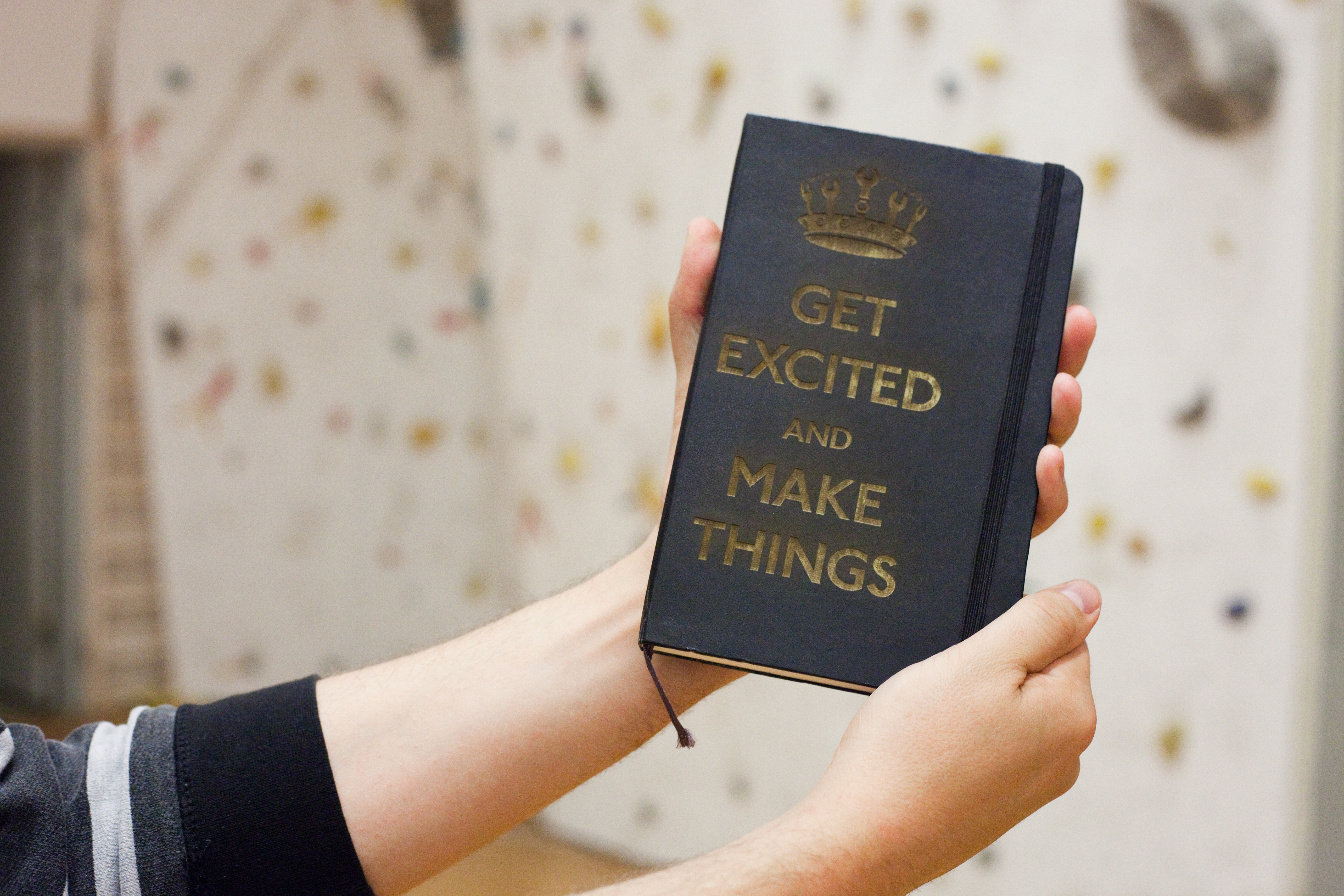 A Moleskine notebook laser-etched with the 'Get Excited and Make Things' design